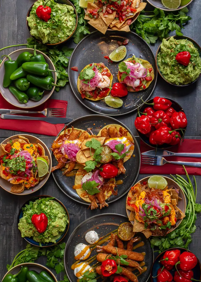 Catering spread from La Taqueria with tacos, nachos and guacamole